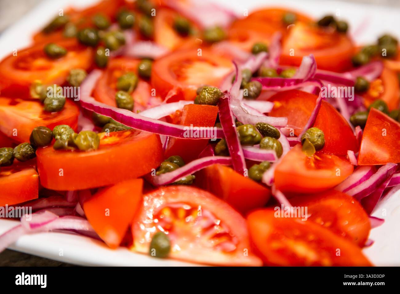 Fresh salad of tomatoes, onions and capers Stock Photo