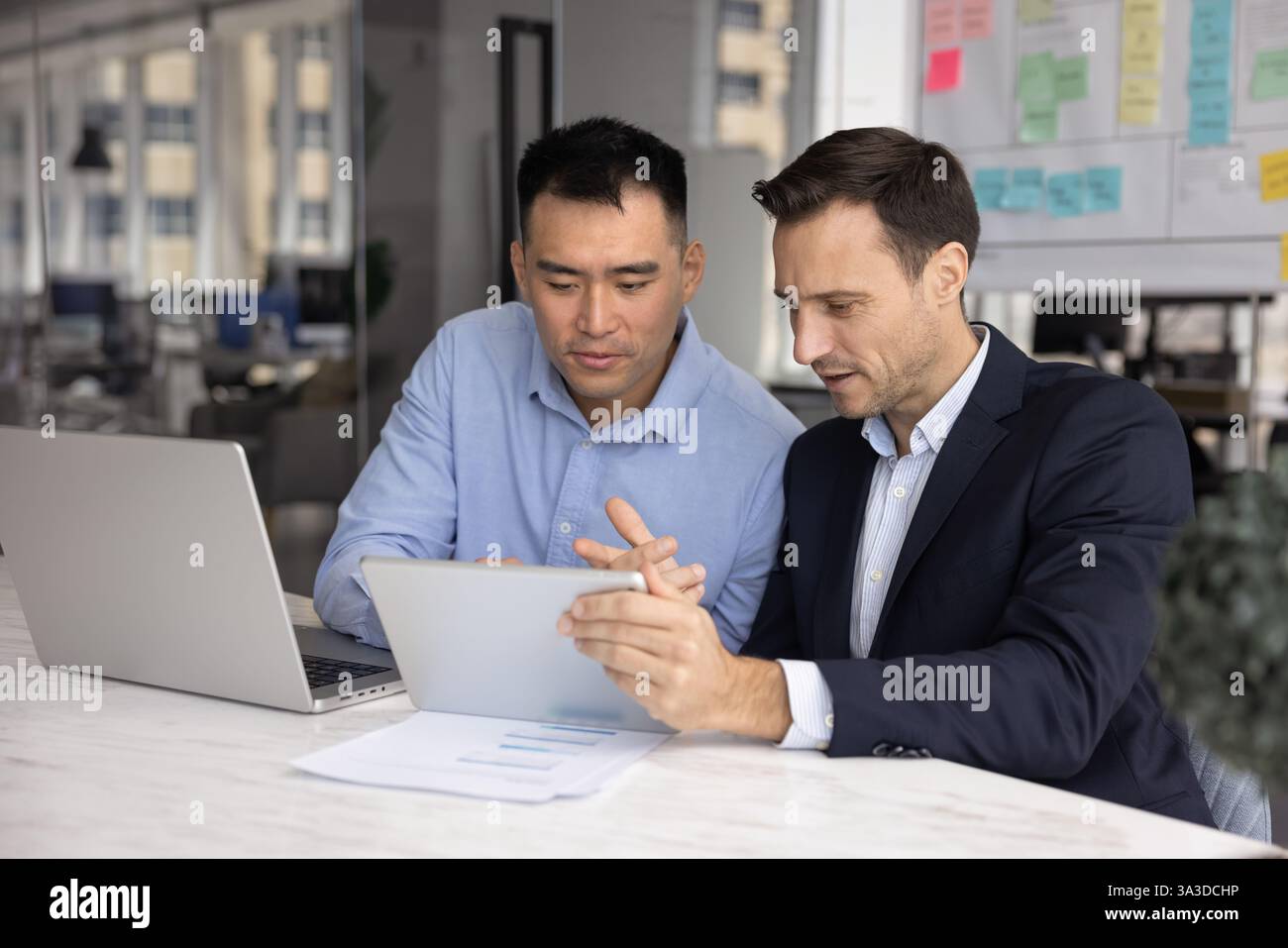 Two diverse company managers working on project together Stock Photo