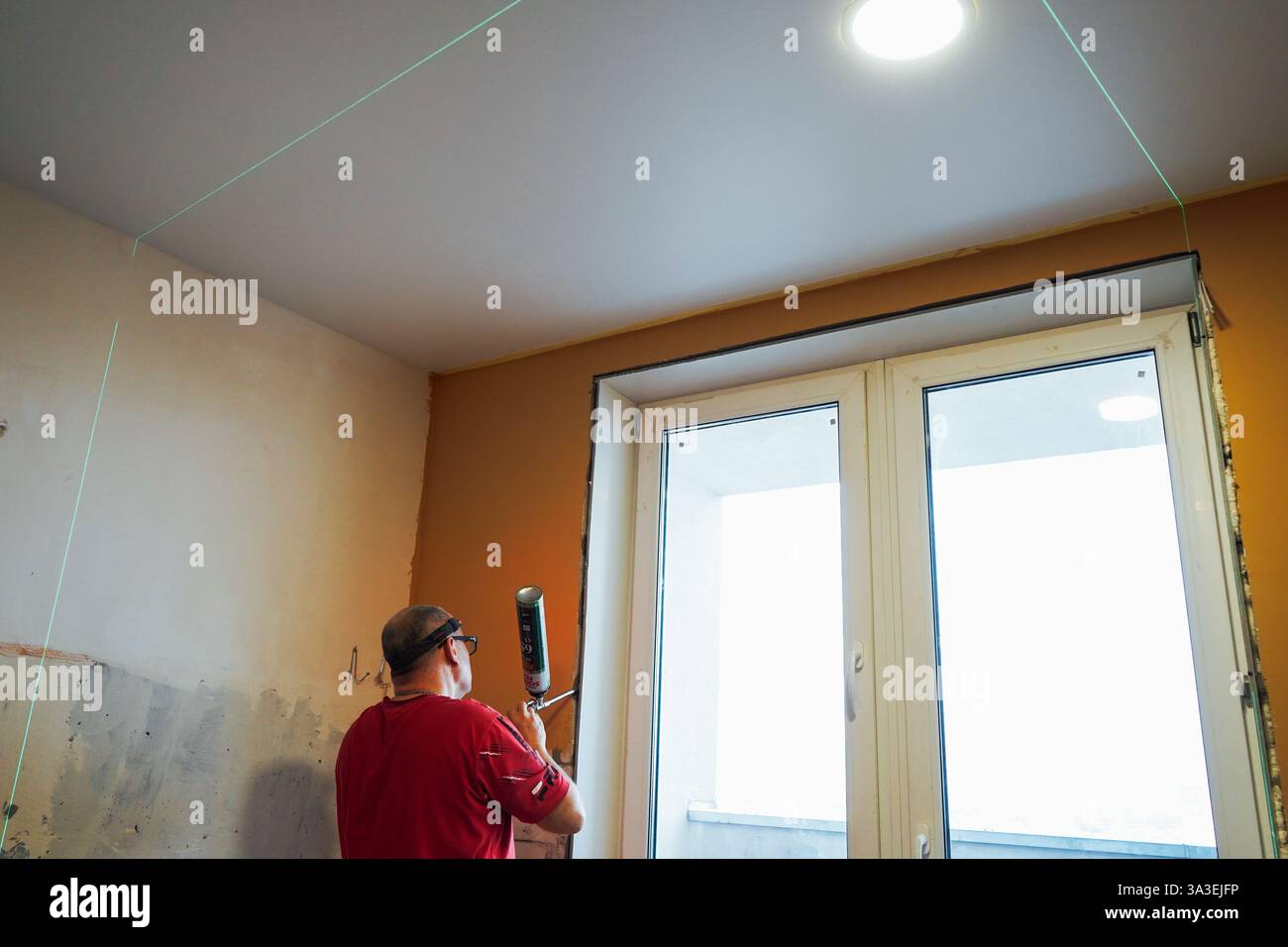 Process installation slopes of window . Using a moanting foam. Stock Photo