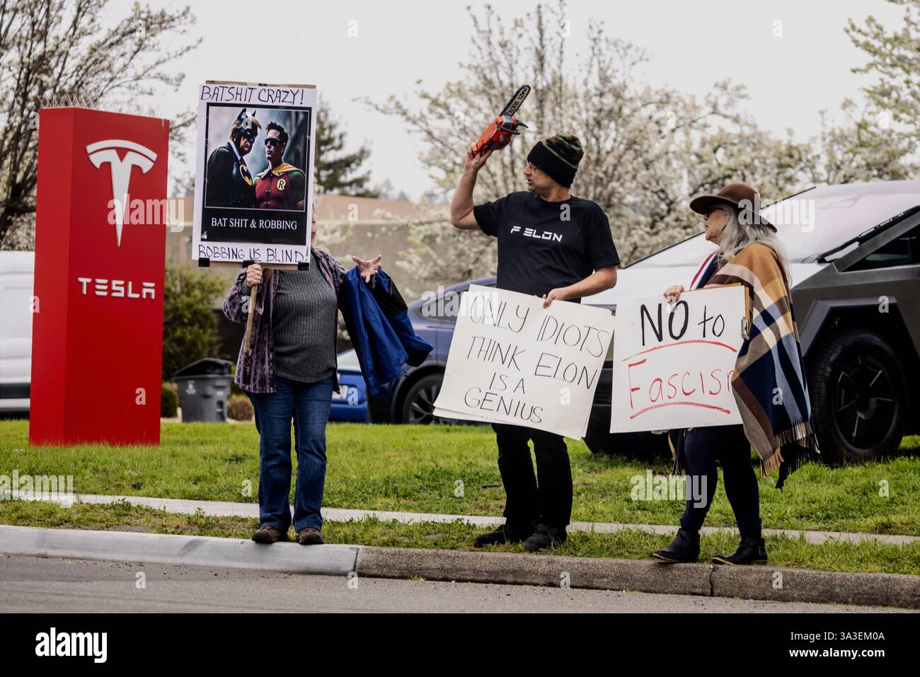 Protesters rally during a protest outside a Tesla showroom against U.S ...
