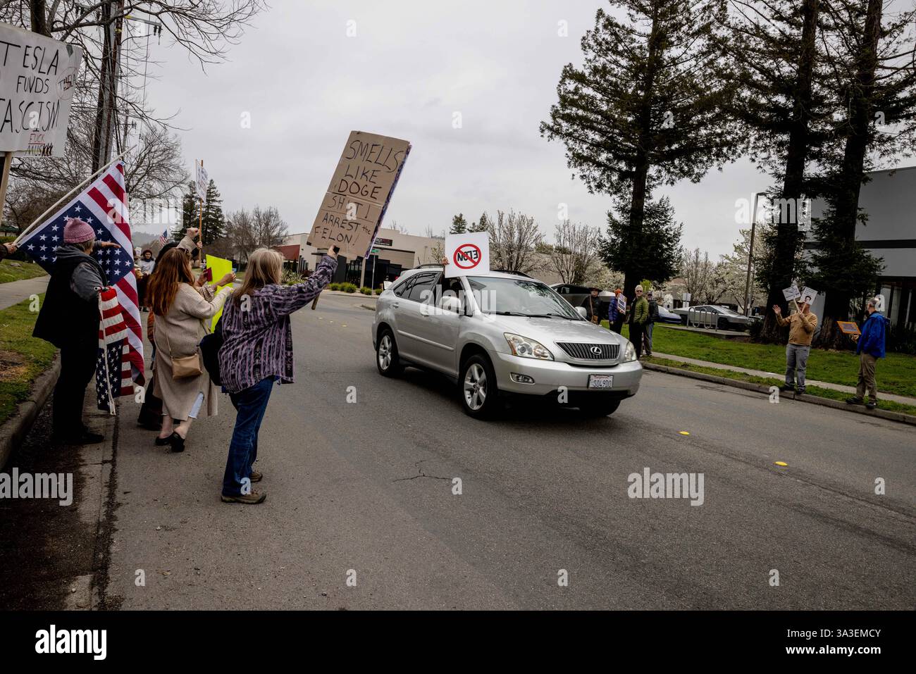 Protesters rally during a protest outside a Tesla showroom against U.S ...