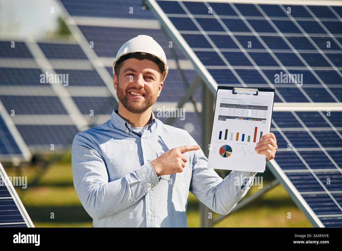 Pointing to the notepad with diagrams and graphs. Engineer with ...