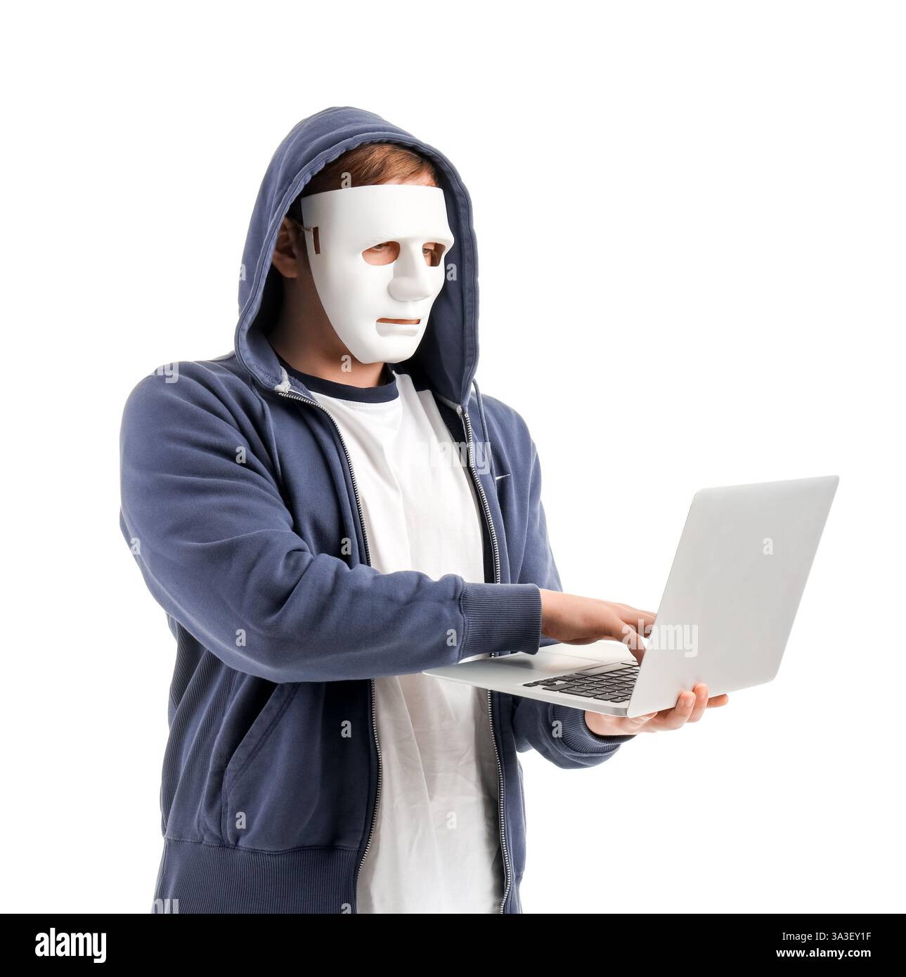 Hacker in mask using laptop on white background Stock Photo