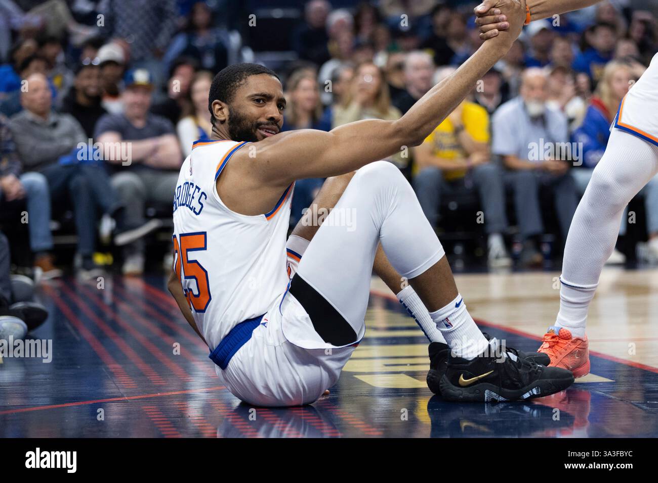 New York Knicks guard Mikal Bridges is helped up during the first half ...