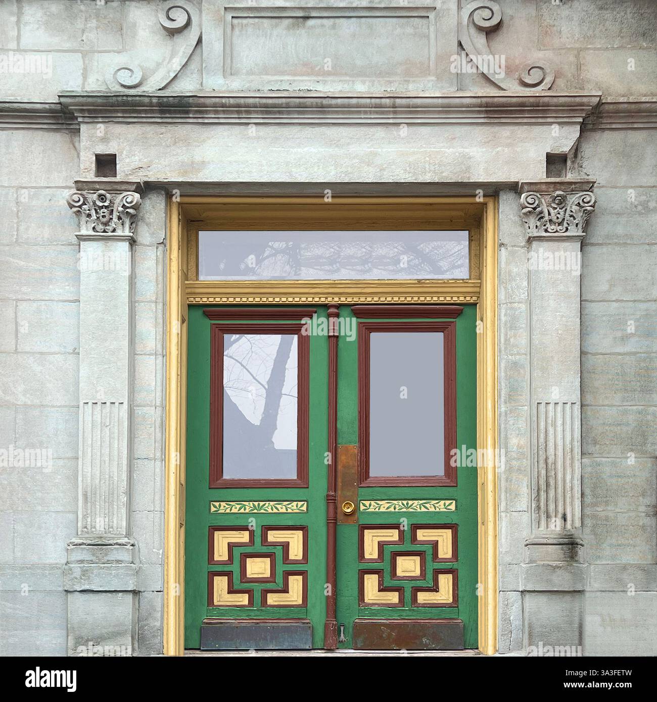 Intricately designed green and gold double doors within a historic limestone facade, featuring ornate Corinthian columns. - Smartphone Captured Stock Image