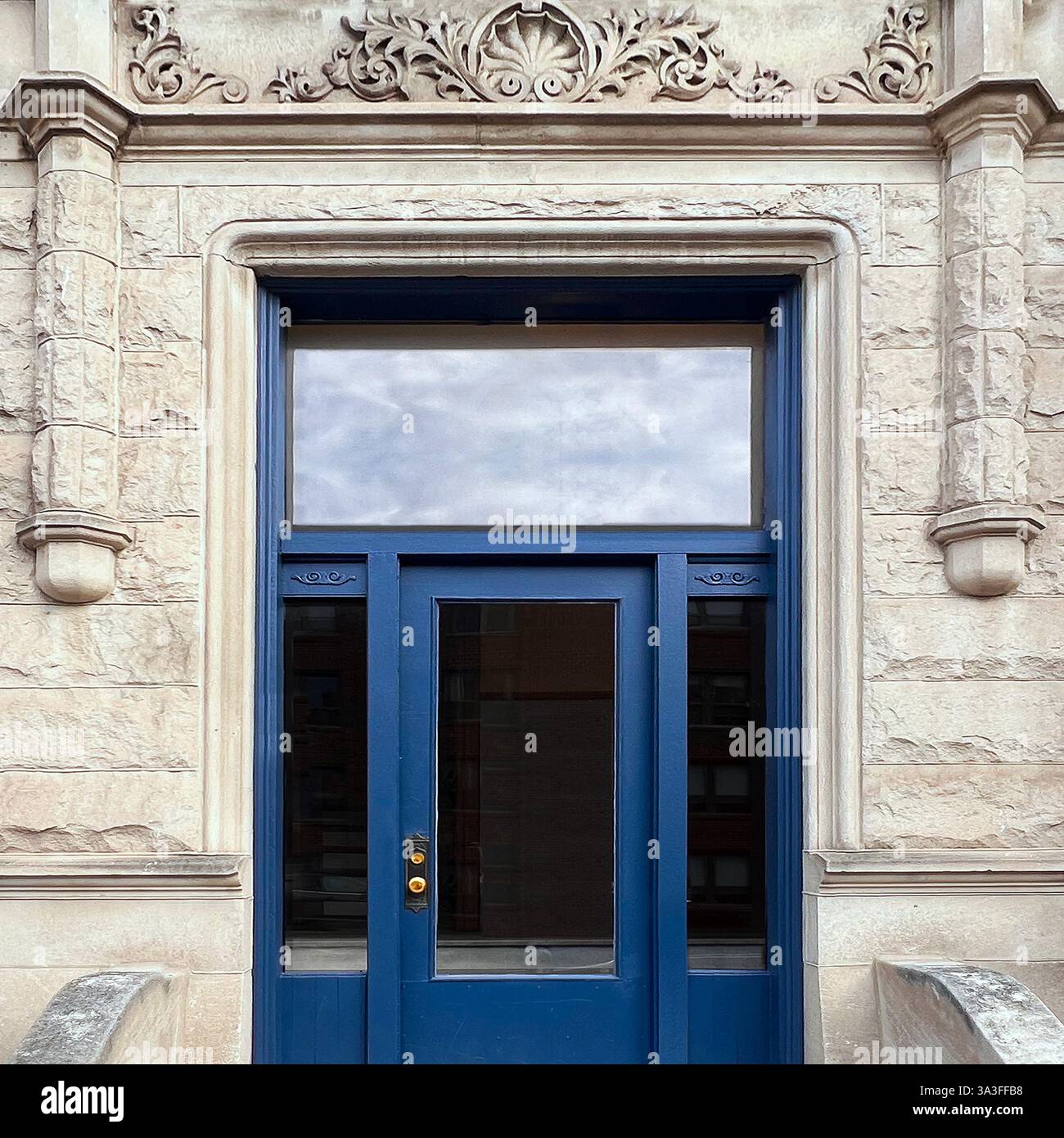 A striking blue door within an ornate stone facade, showcasing classic architectural details in Chicago - Smartphone Captured Stock Image