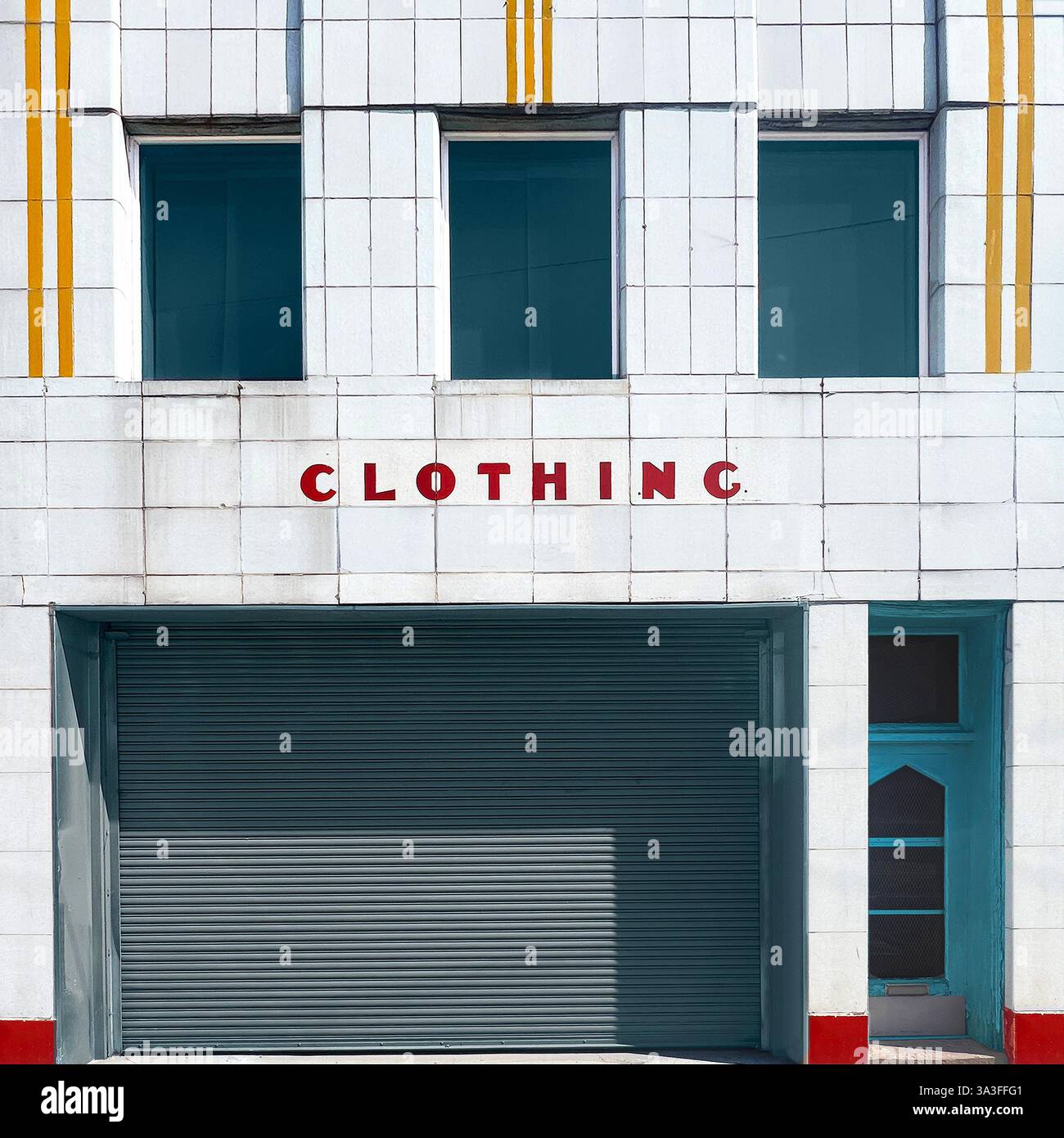 Art Deco clothing store with a bold red-lettered sign,and a weathered white tiled facade with yellow accents, capturing Chicago storefront nostalgia. - Smartphone Captured Stock Image