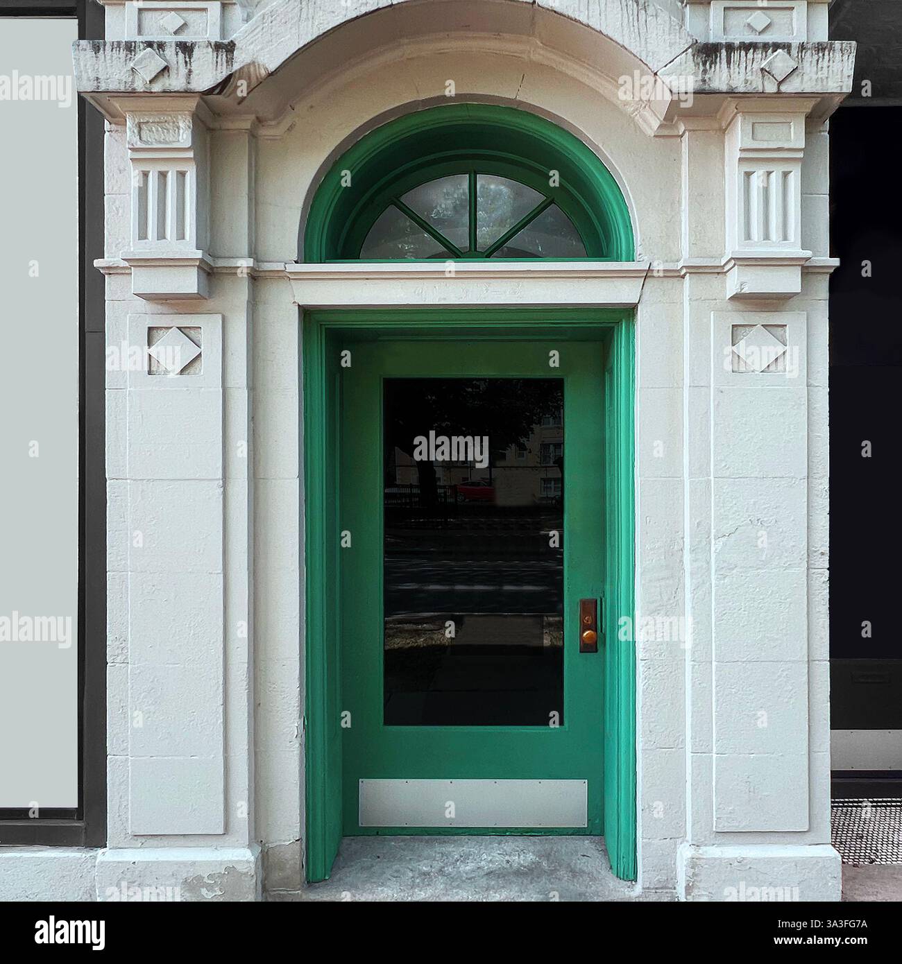 Elegant green doorway framed by detailed architectural stonework in Chicago. - Smartphone Captured Stock Image