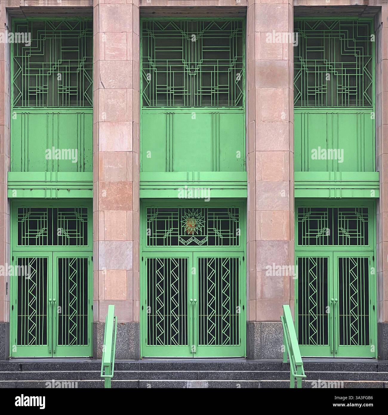 Art Deco building facade with striking mint green geometric doors, windows, and metal detailing, Chicago. - Smartphone Captured Stock Image