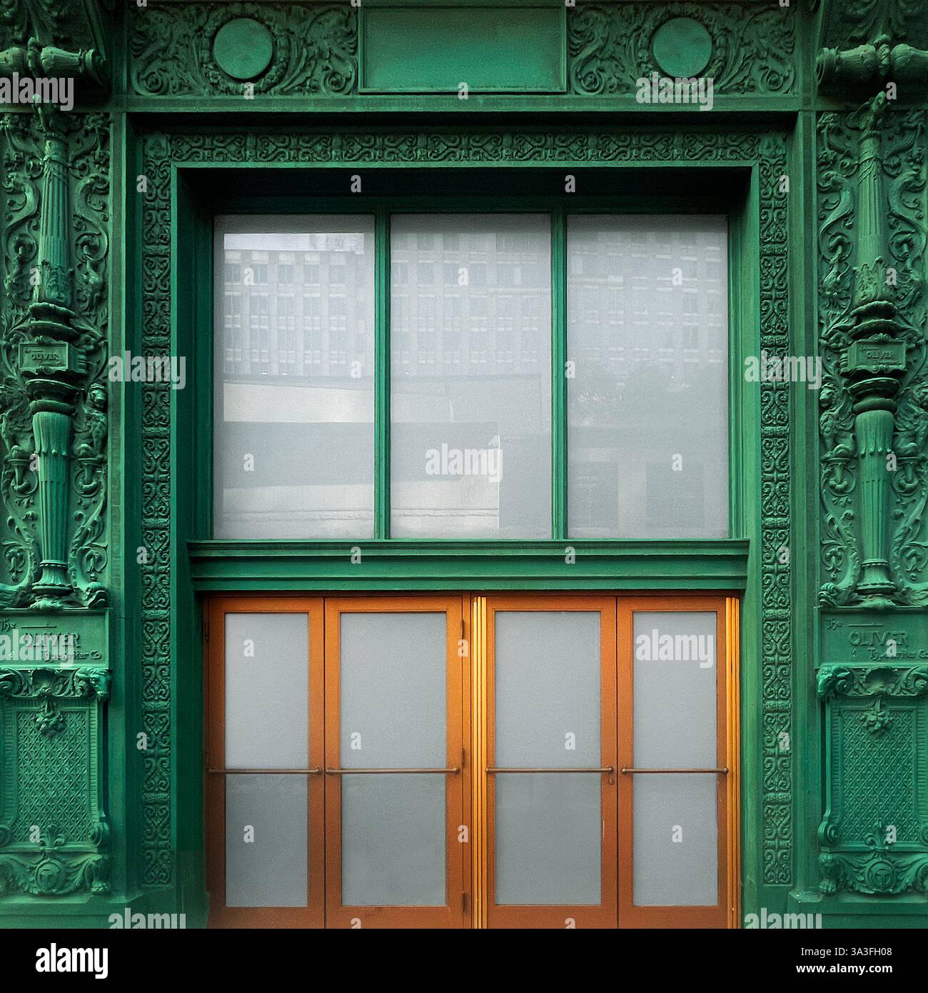 The historic entrance of the Oliver Typewriter Company building in Chicago, featuring intricate green cast-iron exemplifying Art Nouveau. - Smartphone Captured Stock Image