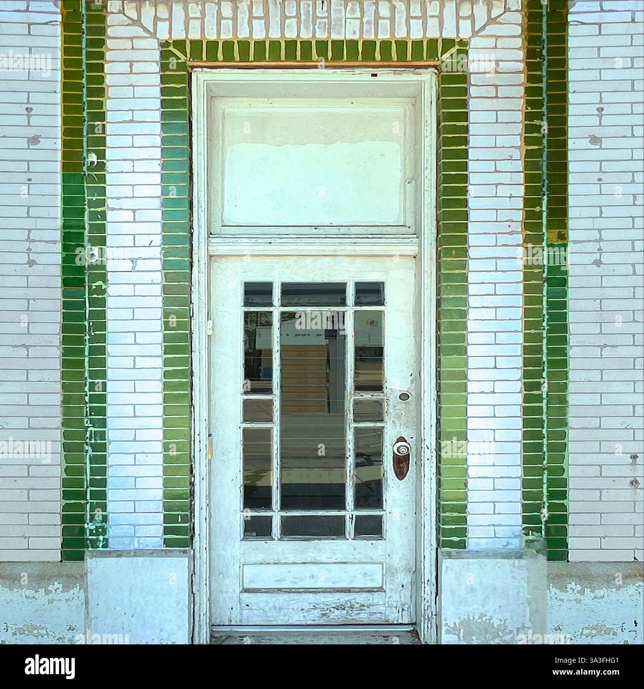 A weathered white door with glass panels, framed by vintage green and white glazed brick in Chicago - Smartphone Captured Stock Image