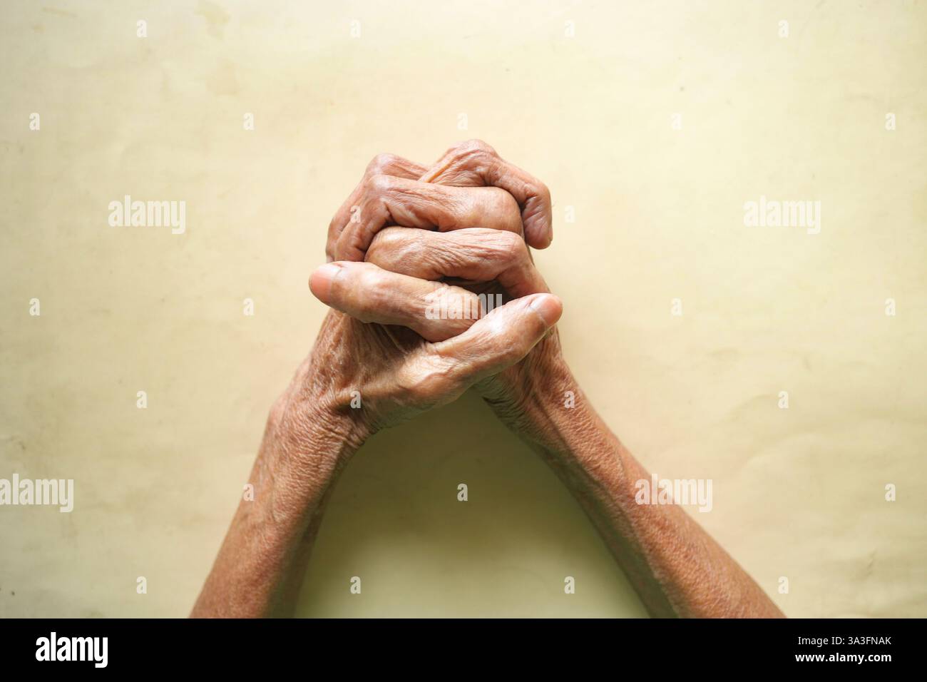 Elderly hands clasped together expressing hope and resilience Stock ...