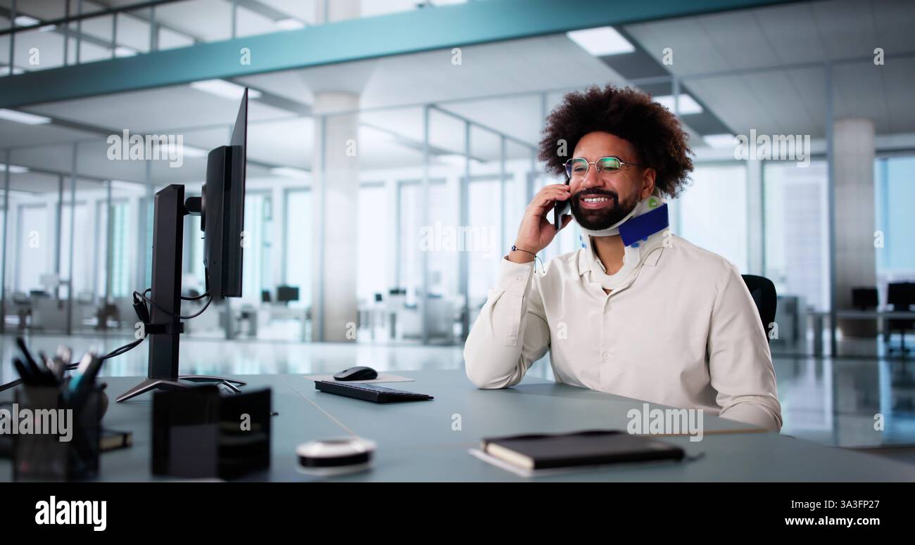 Injured worker with broken arm calling for compensation coverage on smartphone. Stock Photo