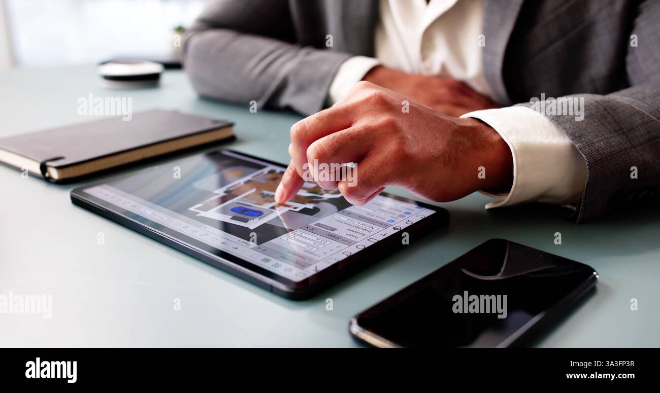 Architect meticulously examining and digitizing house floor plan design. Professional engineer. Stock Photo