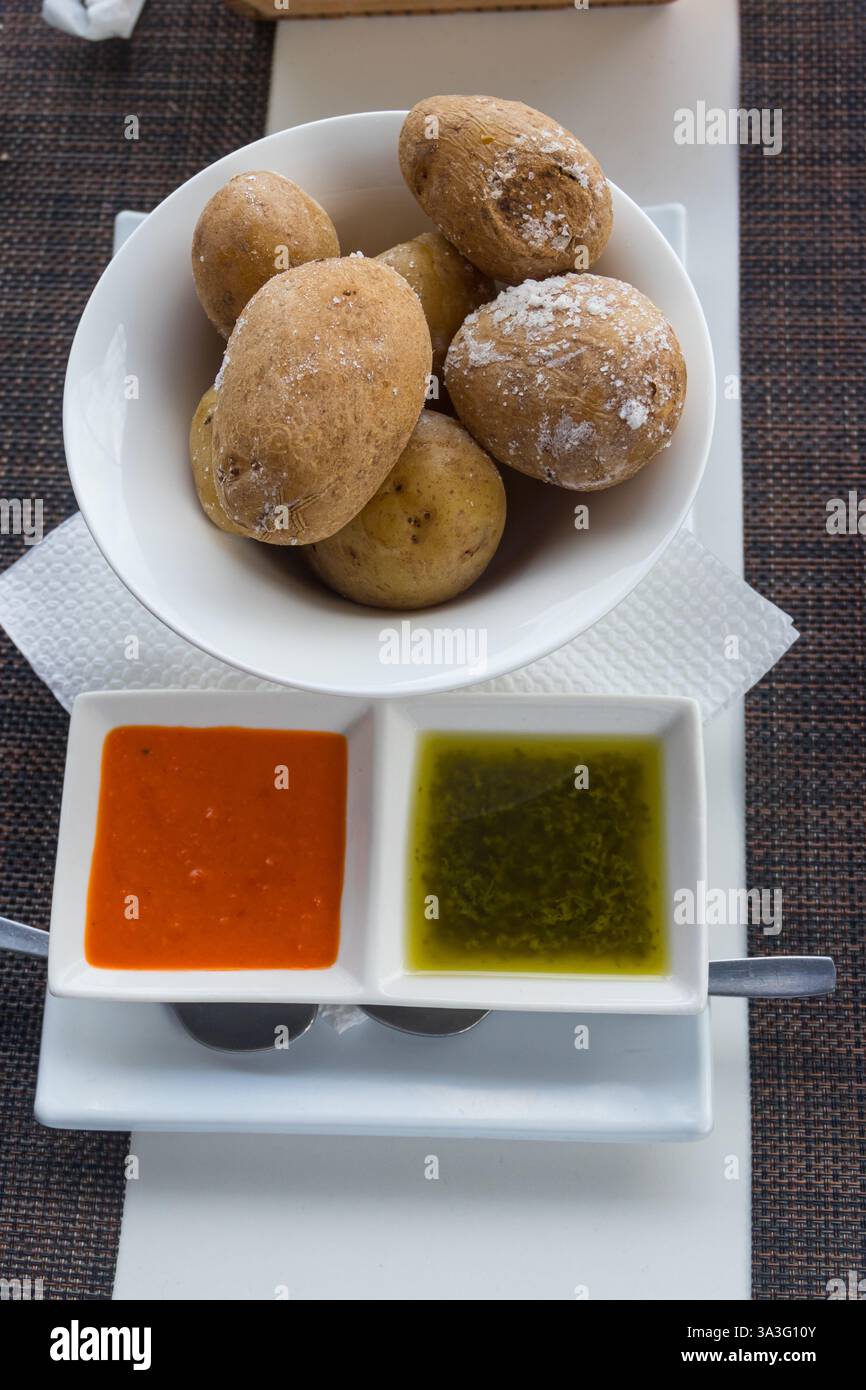Portion of canarian potatoes (papas arrugadas) with red and green mojo sauce. Typical dish of the Canary Islands Stock Photo