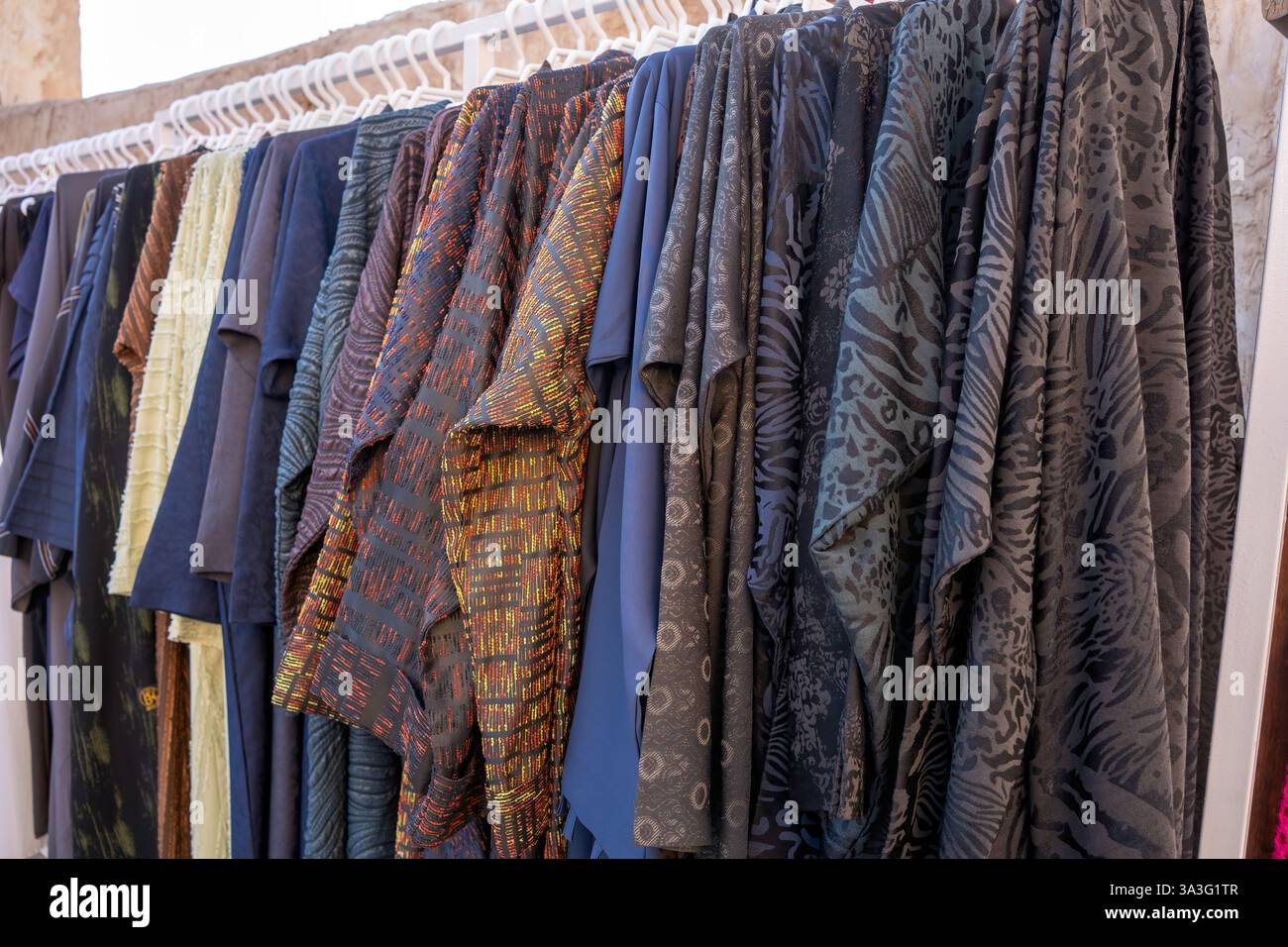 Beautiful female wardrobe. A lot of Abaya dresses hanging on hangers in  closet. Women's space. Small boutique showroom Stock Photo - Alamy