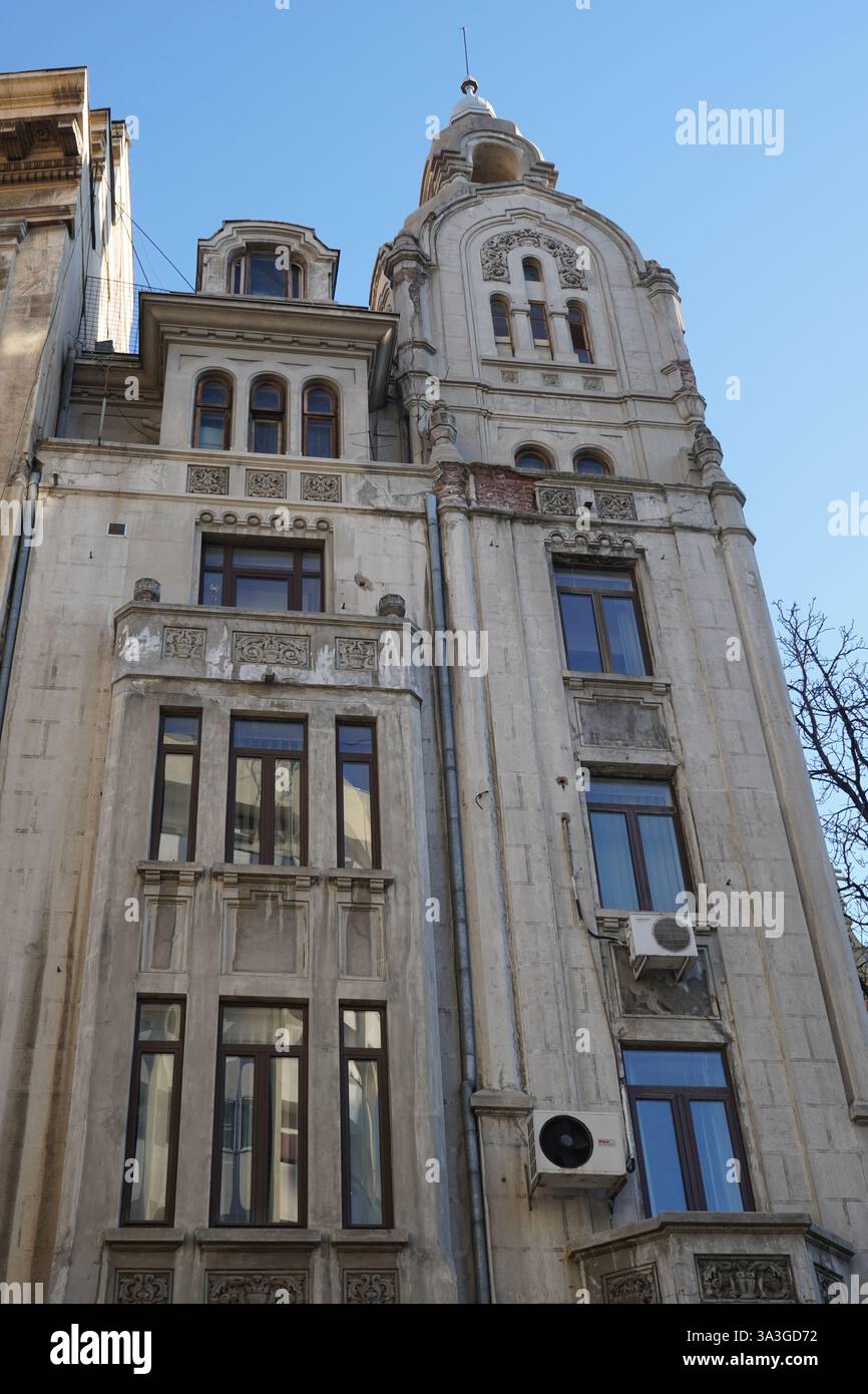 Old building with elements of neo-romanian architectural style in Bucharest Stock Photo