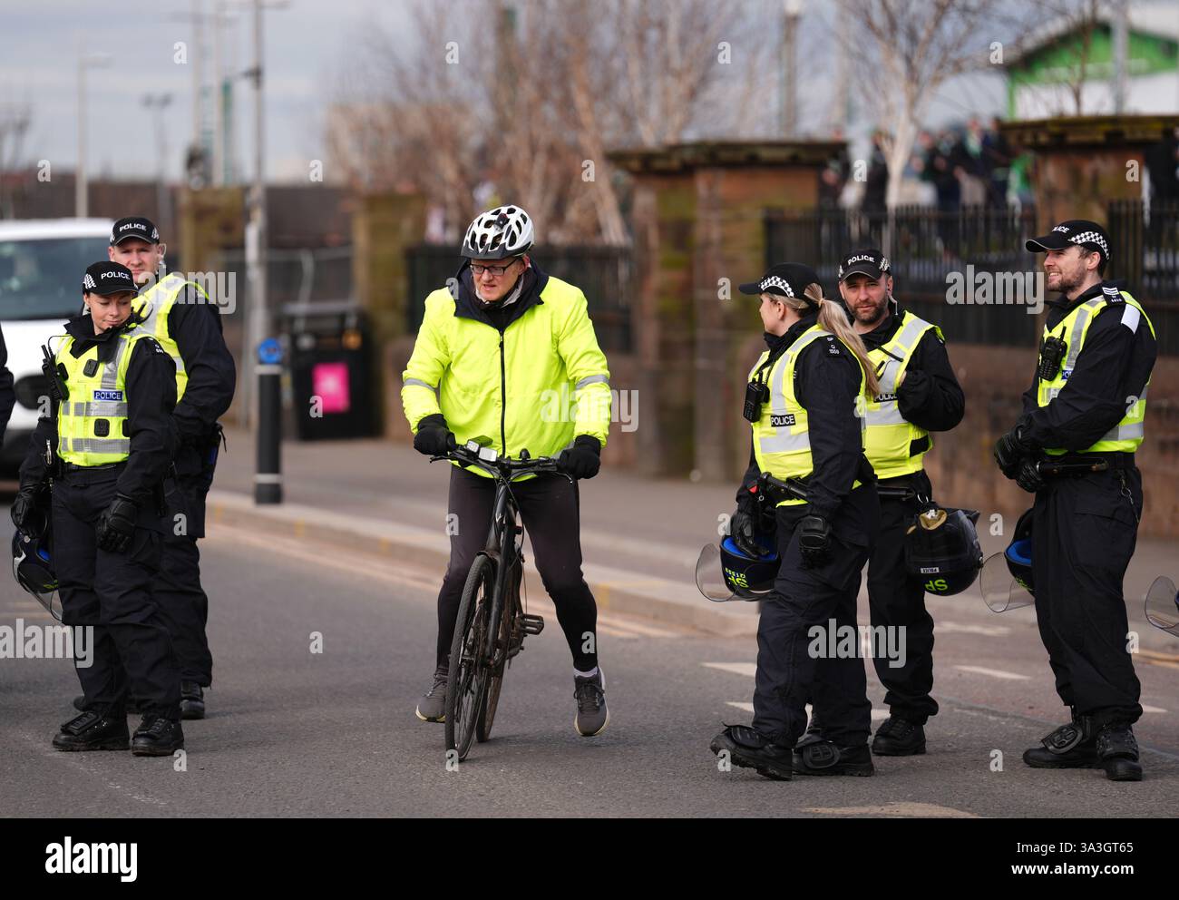 A Cyclist and police officers ahead of the William Hill Premiership ...