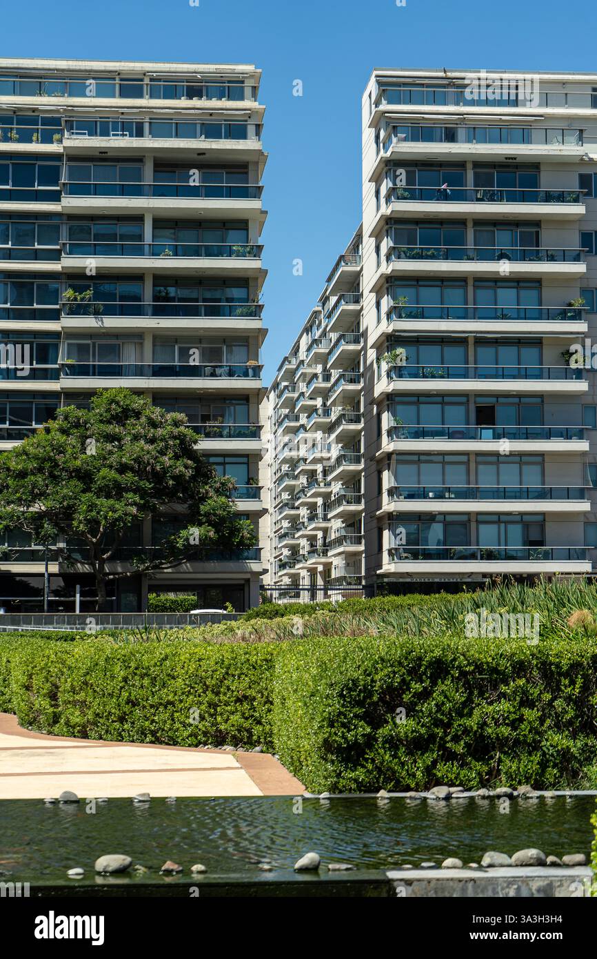 Two modern apartment buildings stand tall, overlooking a beautifully ...