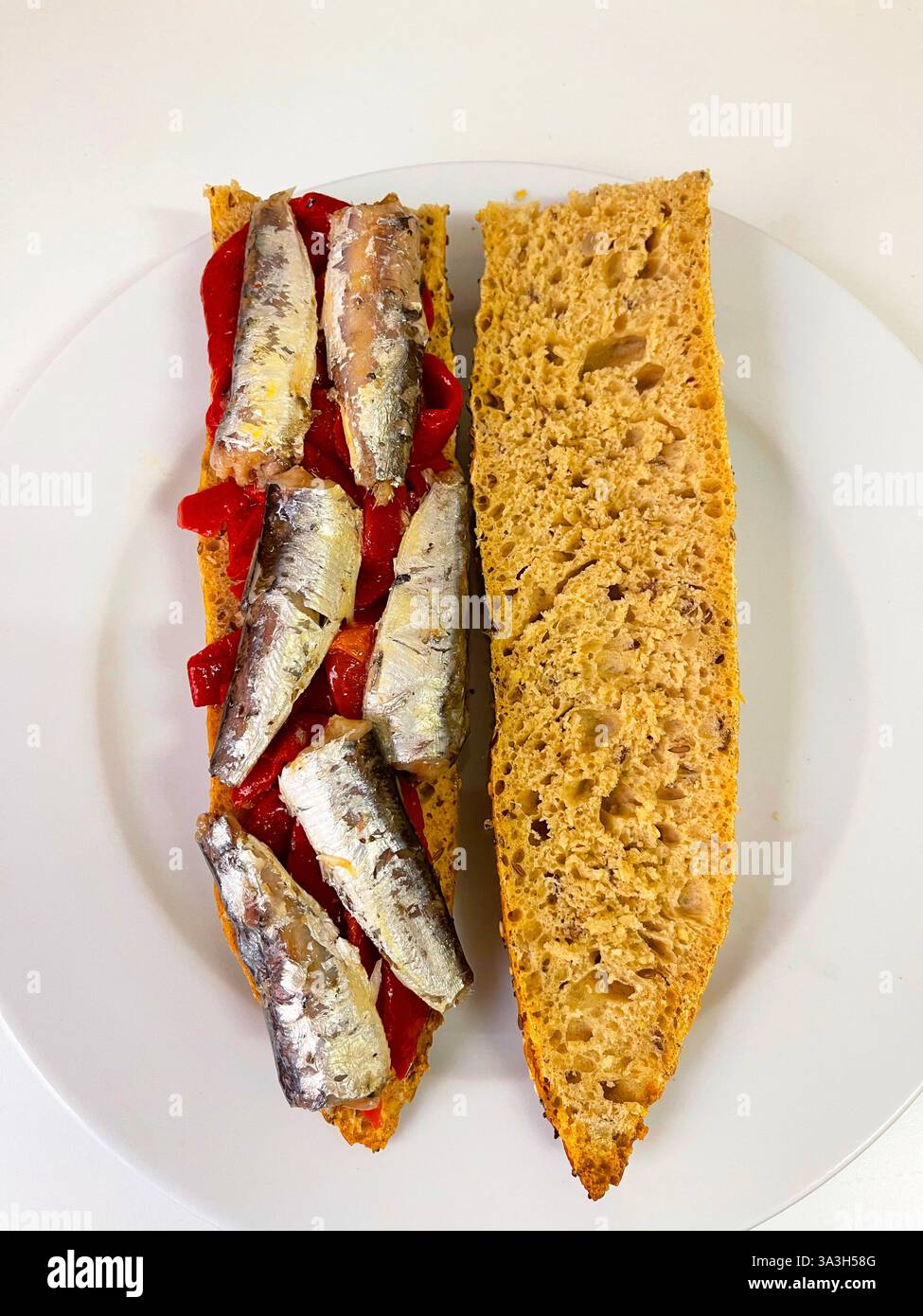 Sardines with red peppers on bread. Spain. - Smartphone Captured Stock Image