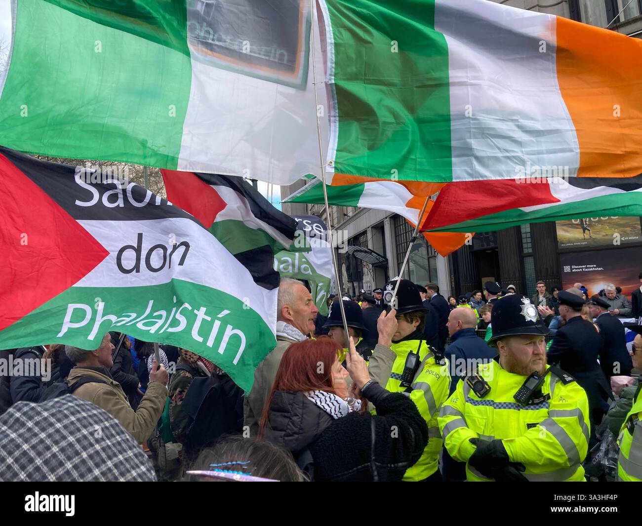 16 March 2025. London. St. Patrick's Day Parade: Police officers stop Irish supporters of Palestine continuing along the official route of the parade. - Smartphone Captured Stock Image