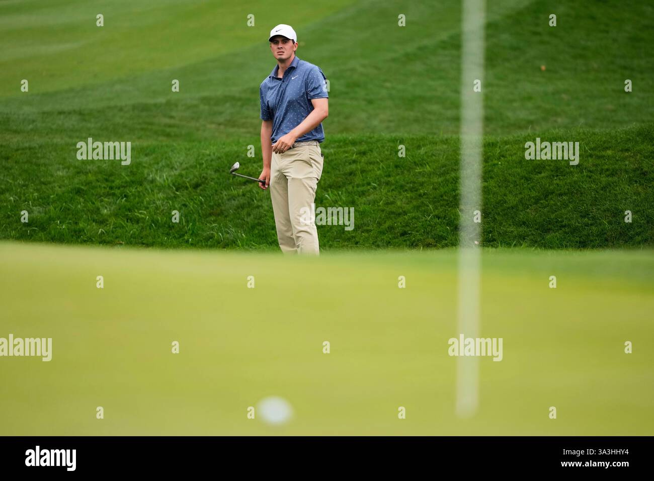 Davis Thompson watches his shot on the second green during the final round of The Players