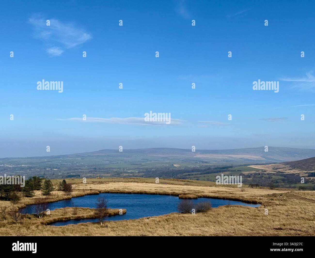 Nicky Nook Fell near Scorton in Lancashire with tarn in foreground looking toward Morecambe Bay in distance - Smartphone Captured Stock Image