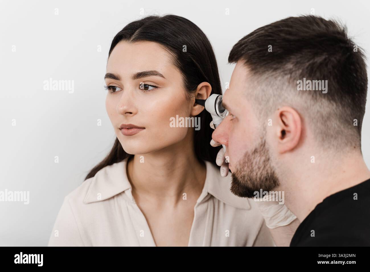 Close-up examination of womans ear with otoscope. Otoscopy. Visit to ...