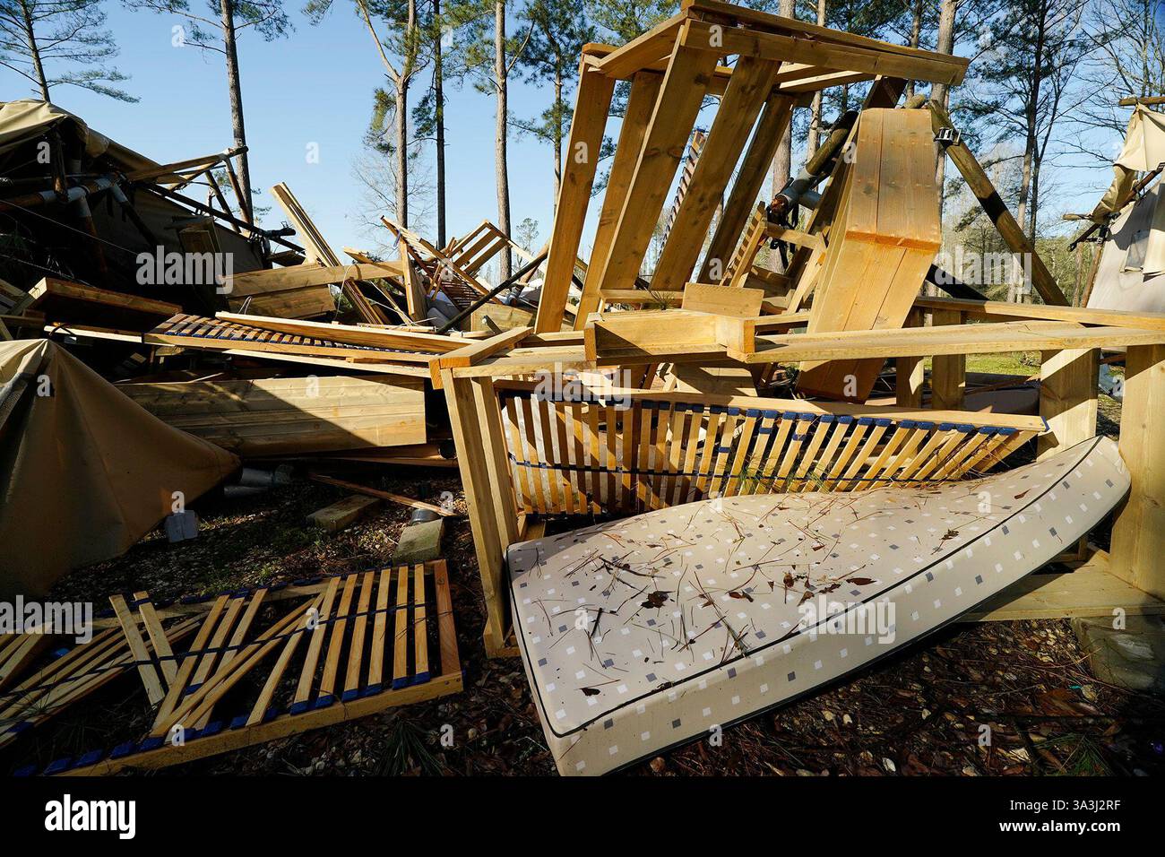 Furniture and kitchen appliances are exposed in the remnants of a ...