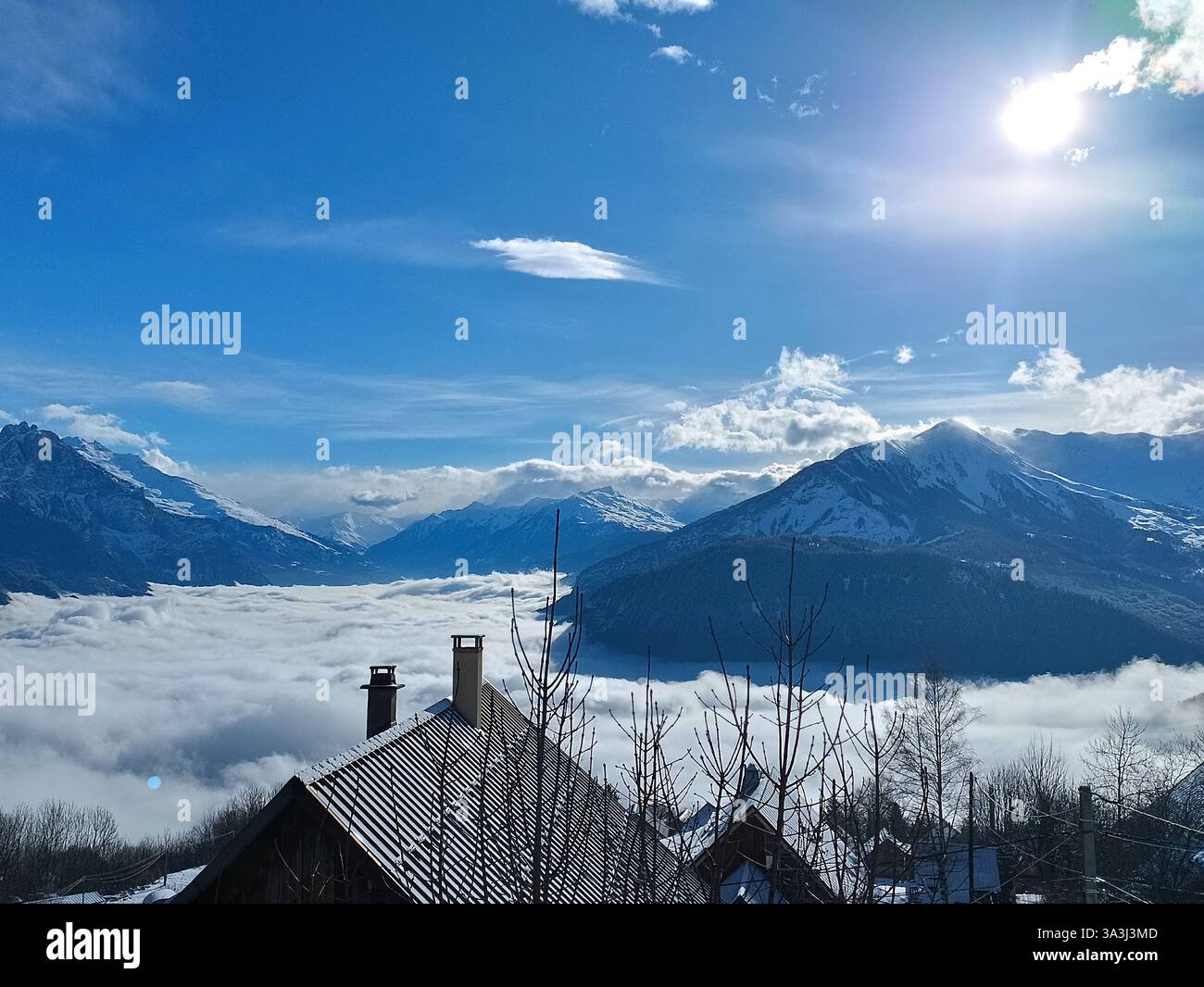 Snowy mountain panorama above clouds, French Alps, Savoie Stock Photo