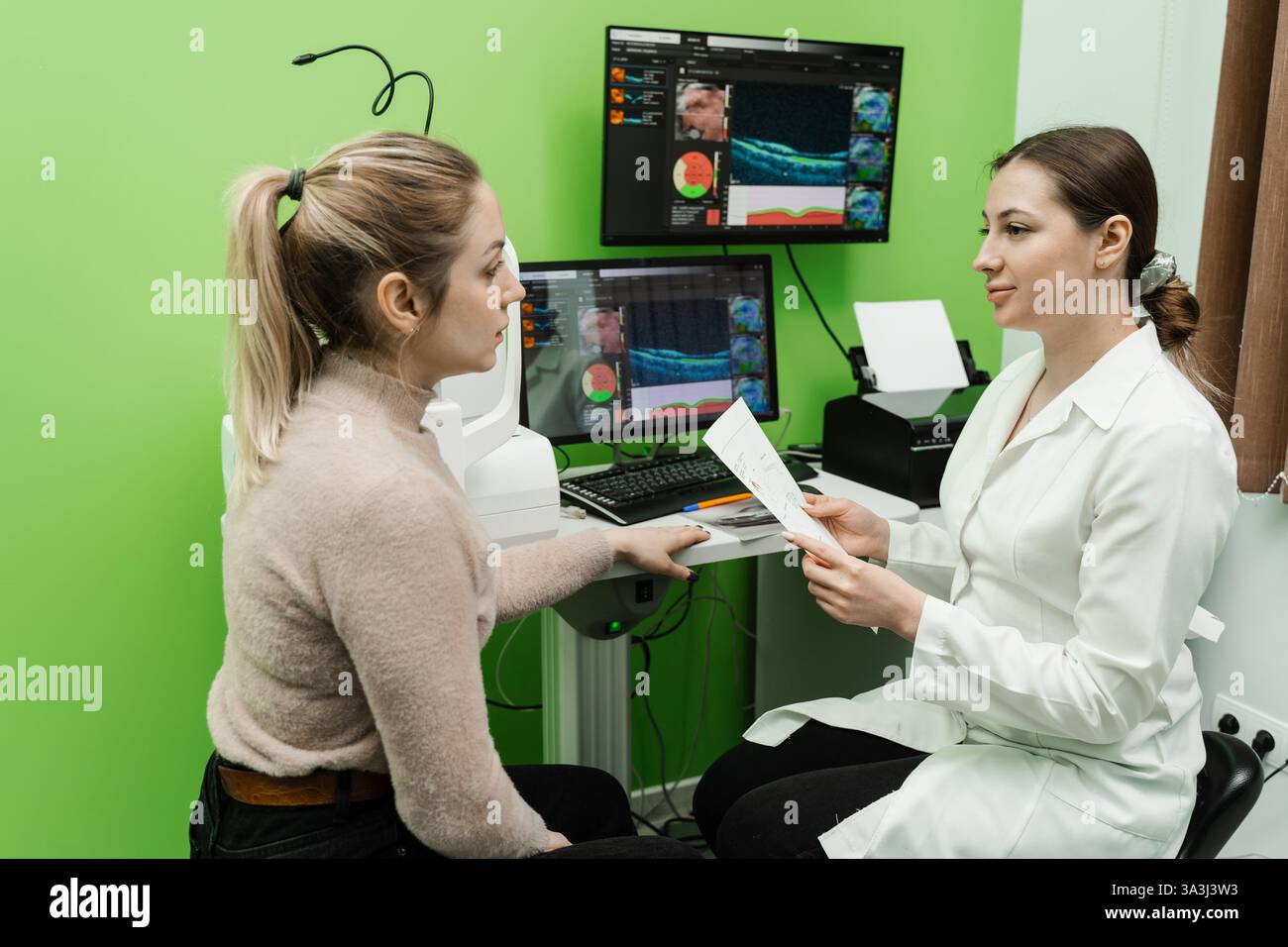Consultation with optometrist with optical coherence tomography OCT ...