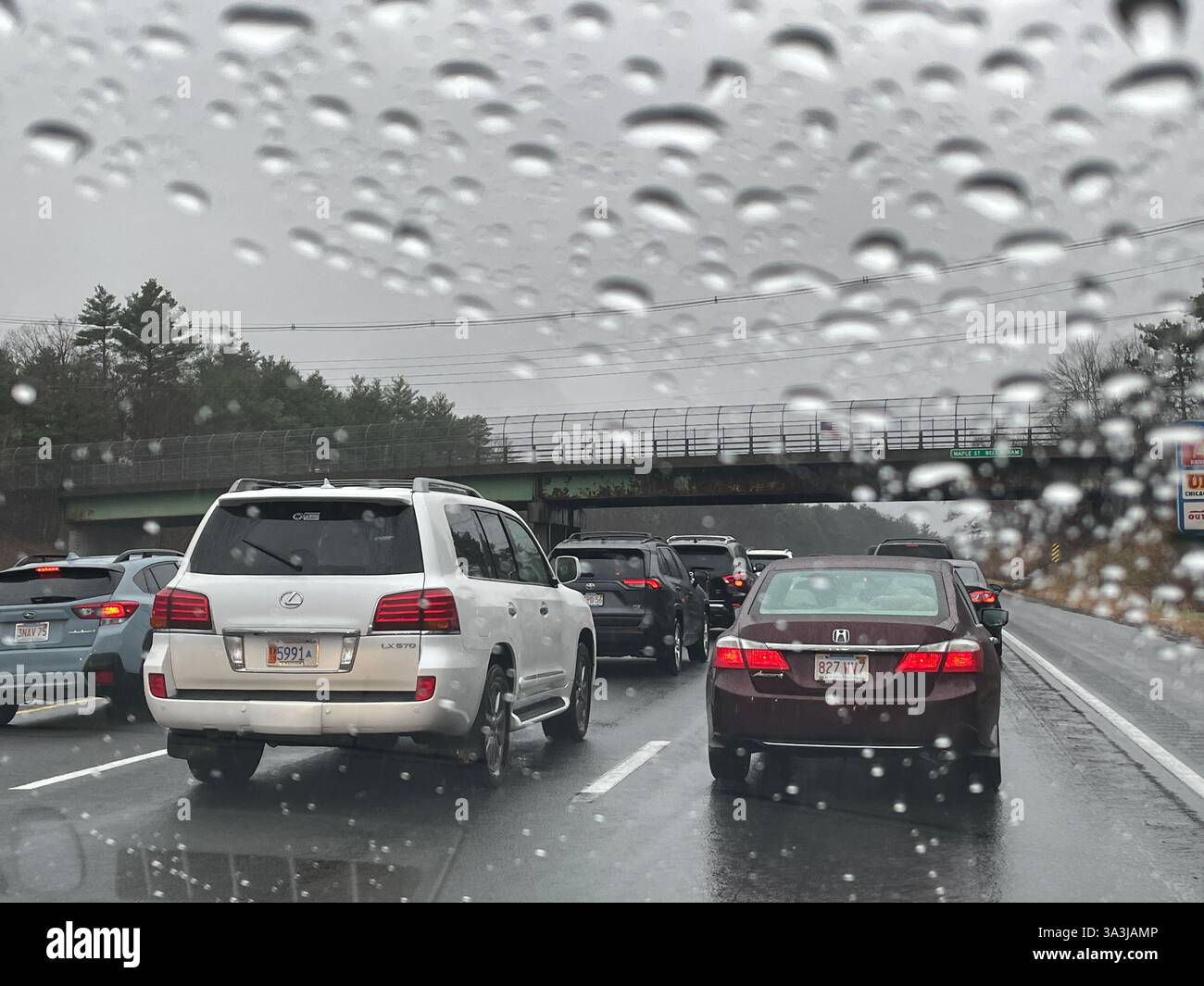 Inclement weather slows traffic on an interstate highway in Massachusetts, 2024, United States - Smartphone Captured Stock Image