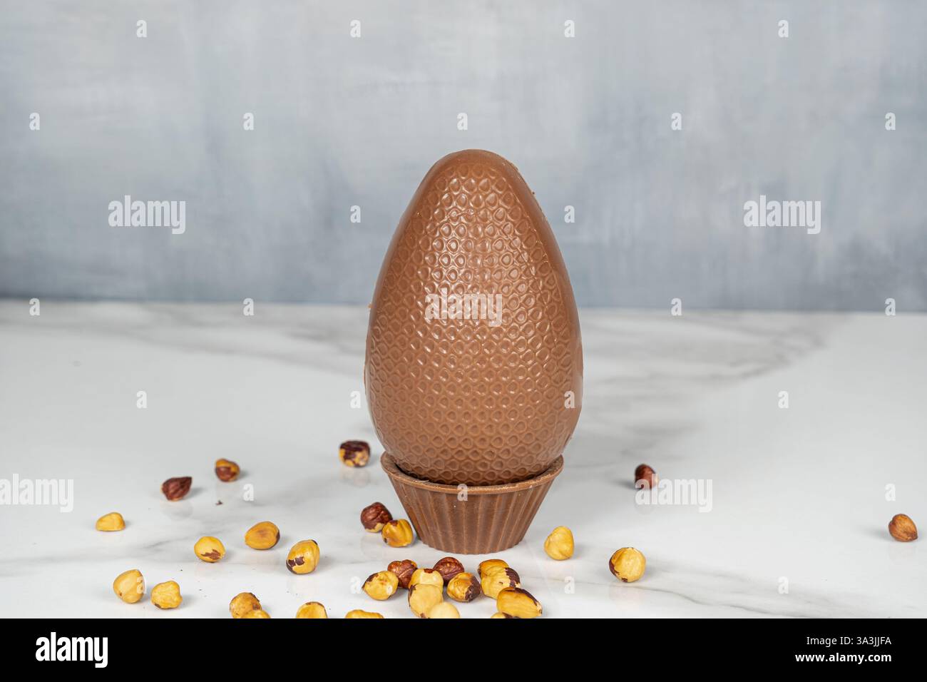 Milk chocolate Easter egg filled with hazelnut cream. Stock Photo