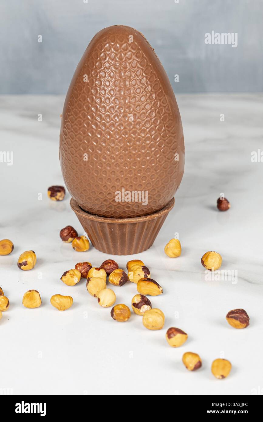 Milk chocolate Easter egg filled with hazelnut cream._vertical Stock Photo