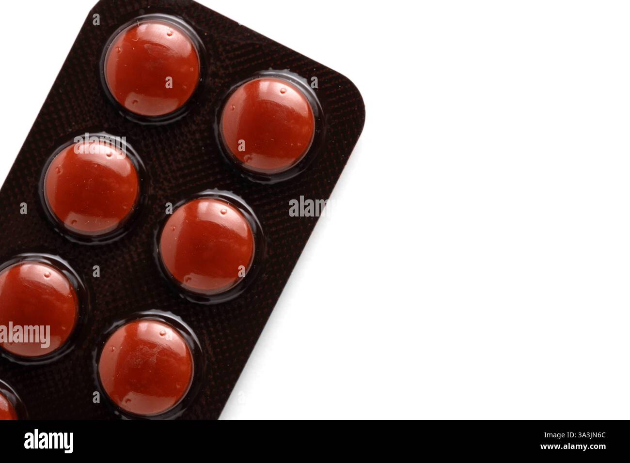 Red pills in blister pack isolated on white background. Top view Stock Photo