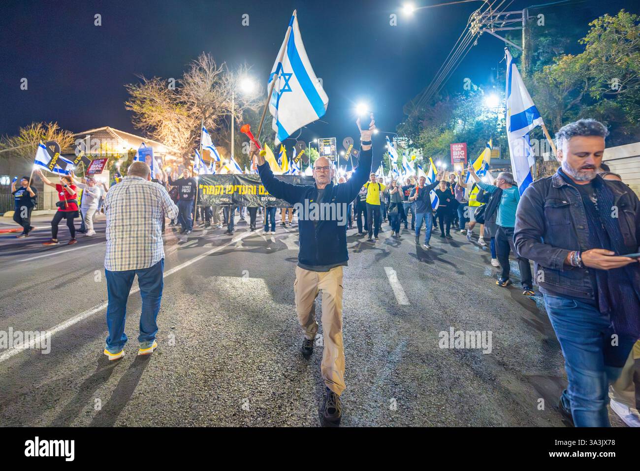 Haifa, Israel - March 15, 2025: People with various signs and flags ...