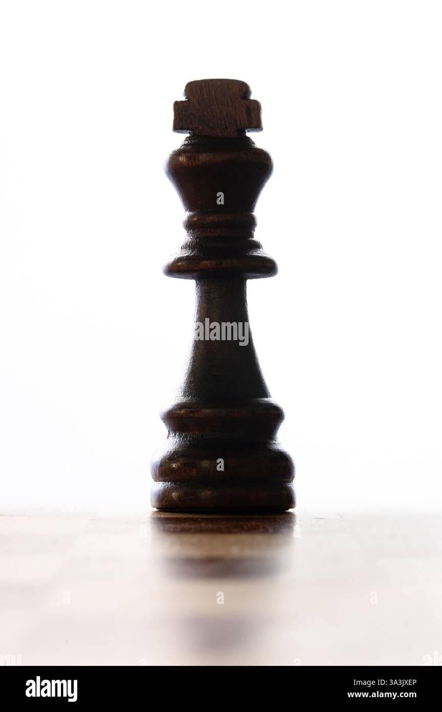 Black king chess piece on a white background, vertical Stock Photo