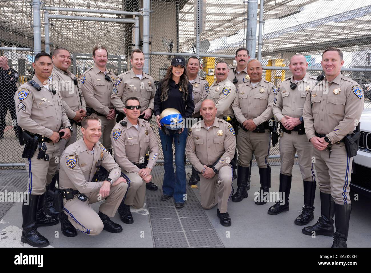 Homeland Security Secretary Kristi Noem, center, poses with members of the California Highway