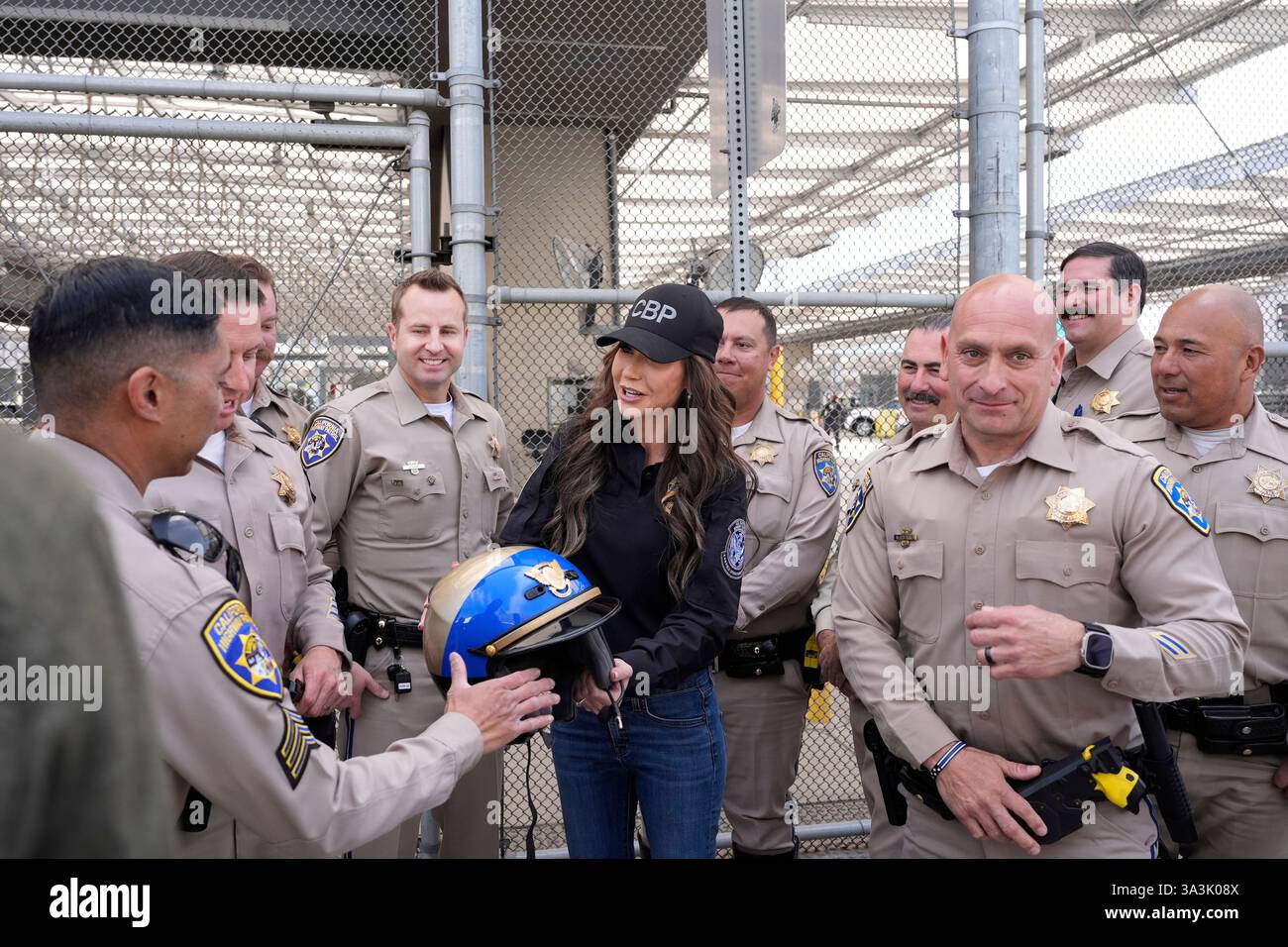 Homeland Security Secretary Kristi Noem, center, greets members of the California Highway patrol