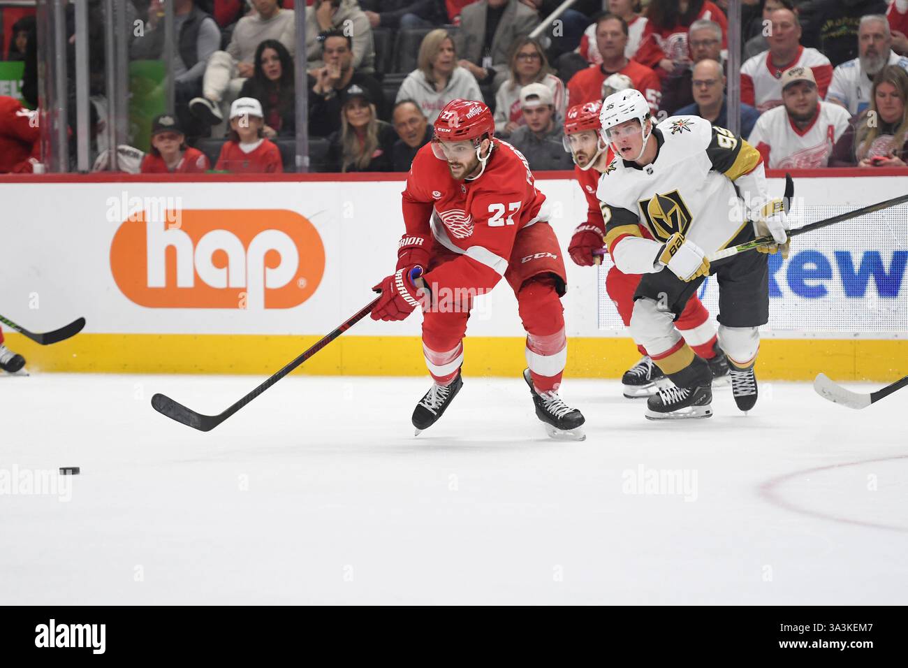 Detroit Red Wings center Michael Rasmussen, left, goes for the puck in ...