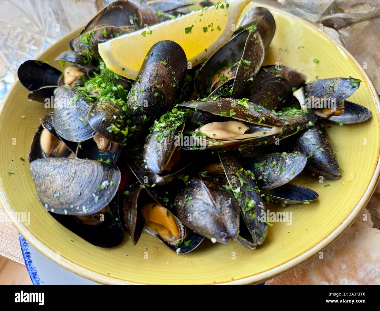 Moules Marinière with a White Wine Garlic Butter Sauce and Lemon - Smartphone Captured Stock Image