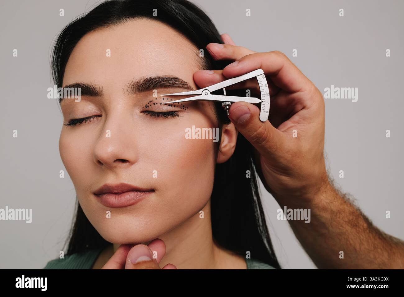 Eye Distance Surgery Upper blepharoplasty. Plastic surgeon is measuring surgical distance ...