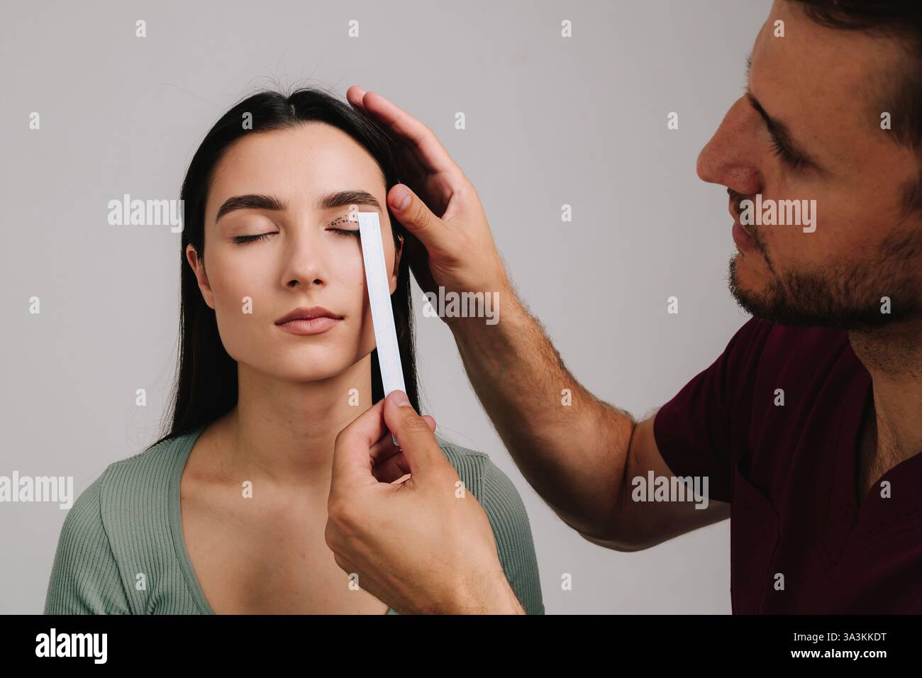 Eye Distance Surgery Blepharoplasty. Plastic surgeon is measuring surgical distance within ...