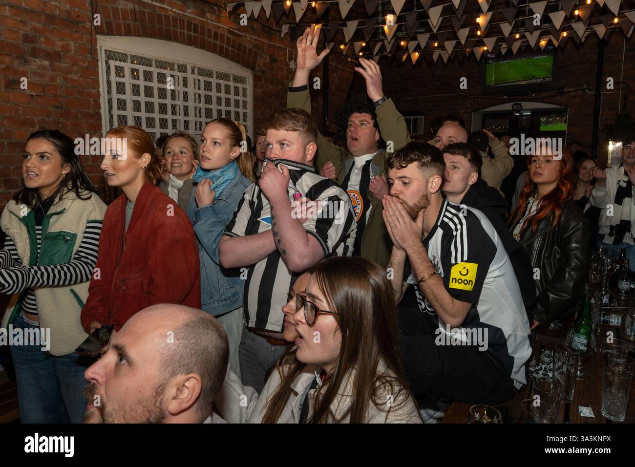 Newcastle upon Tyne, UK. 16th March 2025. Newcastle United fans in the streets. Carabao Cup Final: Newcastle 2 - Liverpool 1. -- Fans outside the Old George pub near the Bigg Market in the city centre.   Credit: Hazel Plater/Alamy Live News Stock Photo