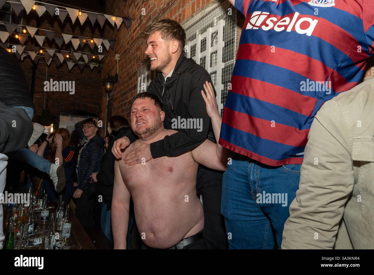 Newcastle upon Tyne, UK. 16th March 2025. Newcastle United fans in the streets. Carabao Cup Final: Newcastle 2 - Liverpool 1. -- Fans outside the Old George pub near the Bigg Market in the city centre.   Credit: Hazel Plater/Alamy Live News Stock Photo