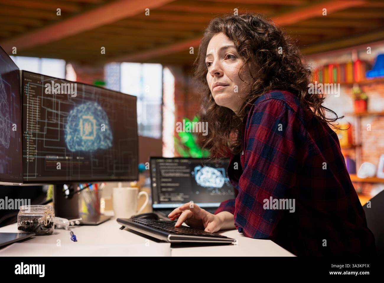 System administrator in startup office coding advanced AI algorithm and machine learning models enhancing automation. IT specialist using PC in artificial intelligence Silicon Valley workplace Stock Photo