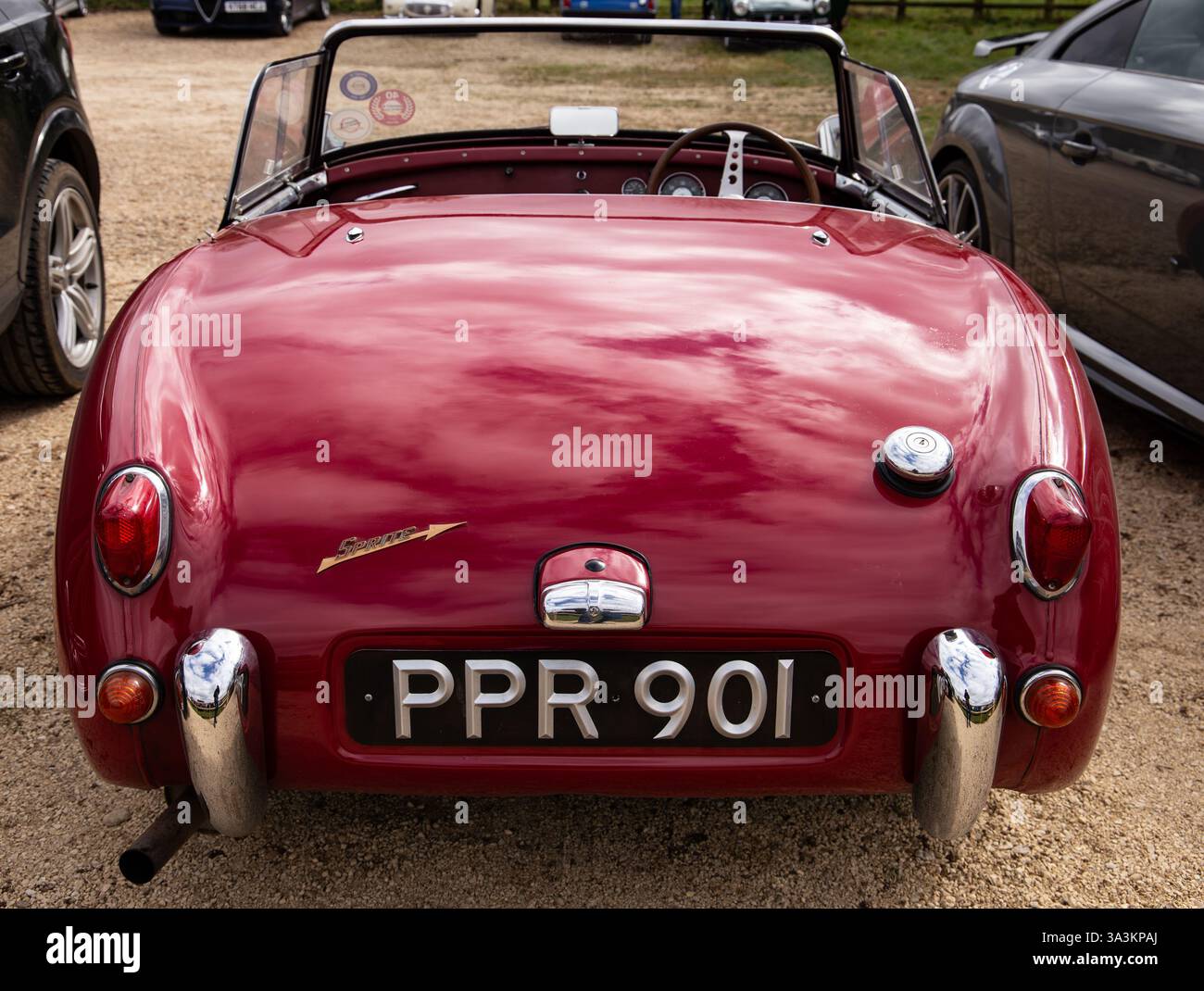 Vintage red sports car 1960 Austin Sprite, parked in a lot, showcasing classic design and license plate PPR 901 Stock Photo
