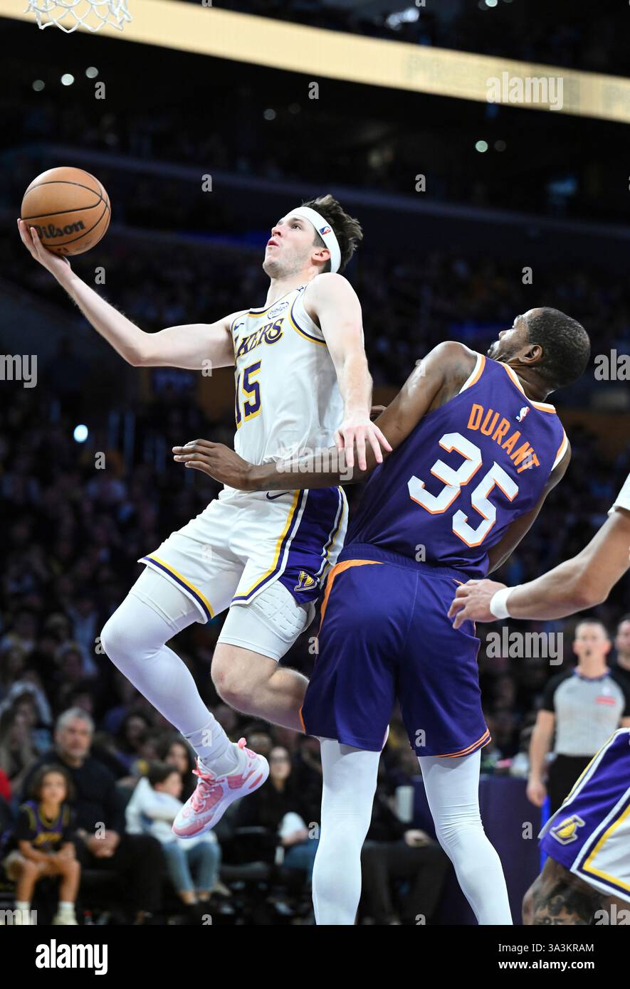 Los Angeles Lakers guard Austin Reaves (15) drives past Phoenix Suns forward Kevin Durant (35