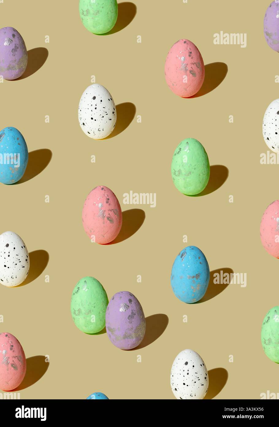 Pattern made of colored eggs on pastel beige background. Minimal Easter concept. Stock Photo