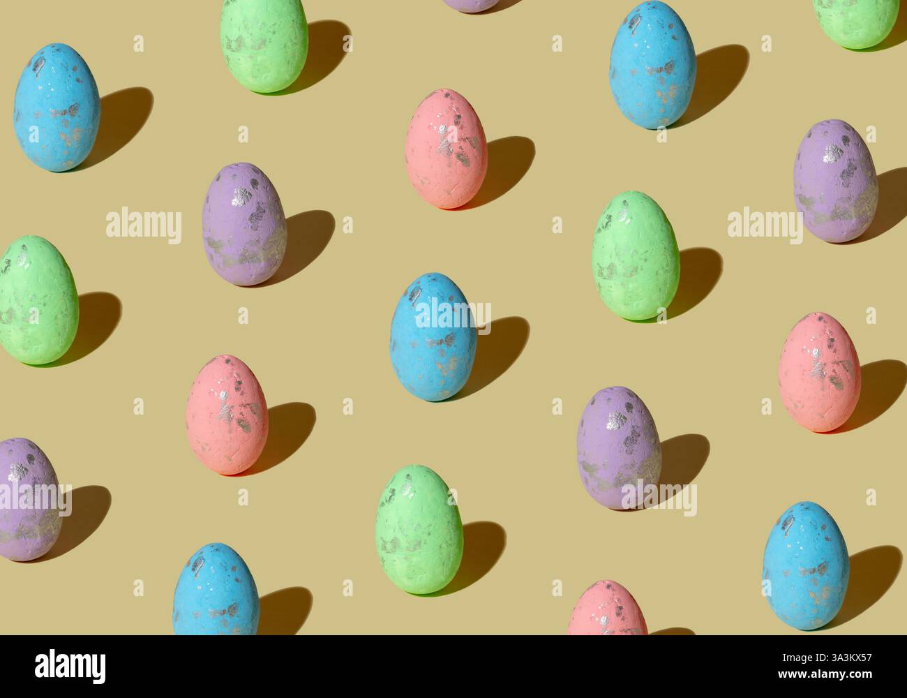 Pattern made of colored eggs on pastel beige background. Minimal Easter concept. Stock Photo